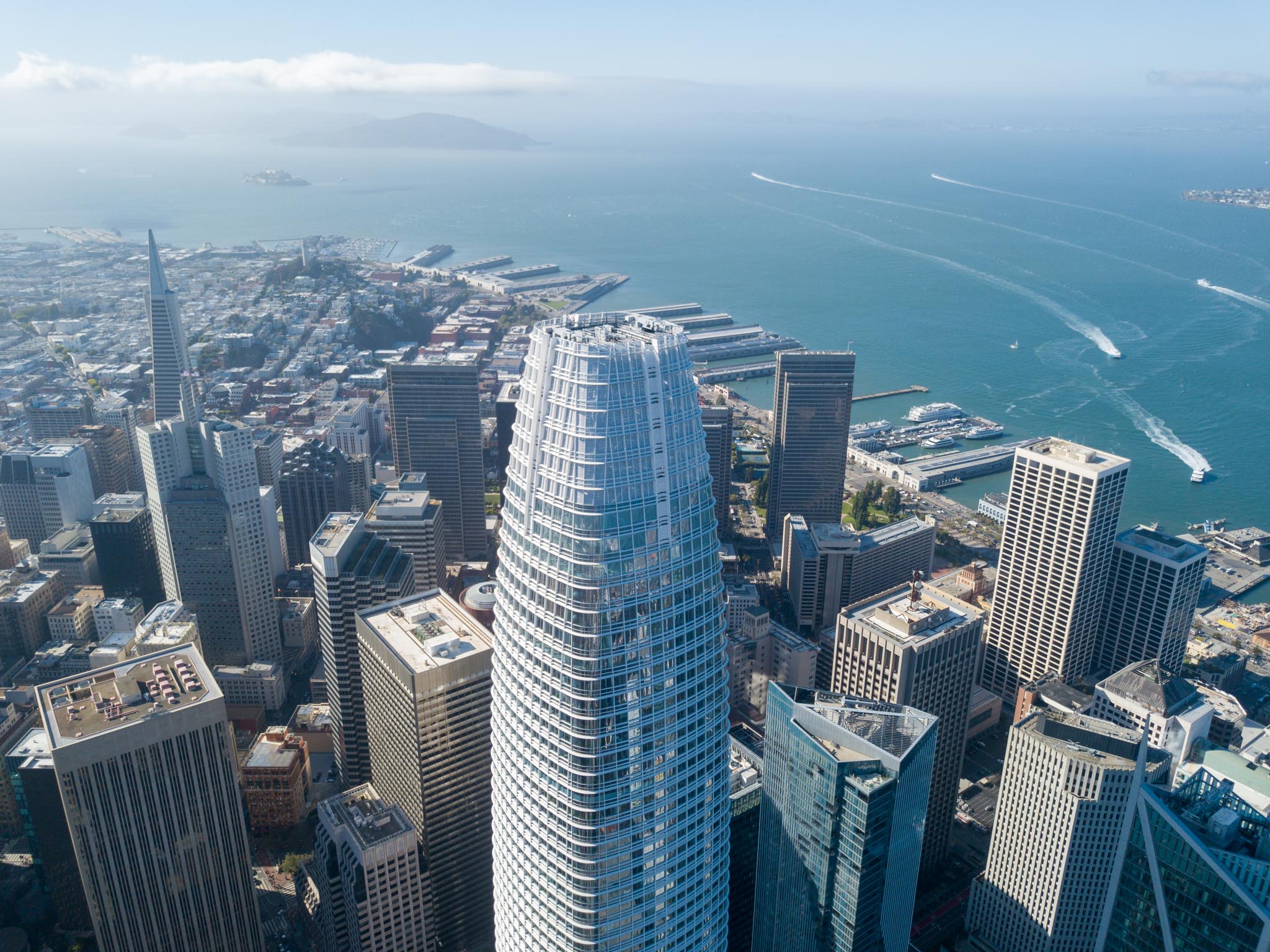 Aerial drone view of San Francisco's Salesforce Tower with the bay behind